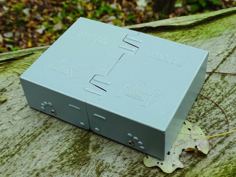 Celkový pohled na velký lihový vařič Esbit v zavřeném stavu. Vypadá tak trošku jako cihla, ale jeho prázdná hmotnost je jen 167 gramů. Velikost pak: délka 130 mm, šířka 95 mm a výška 37 mm.